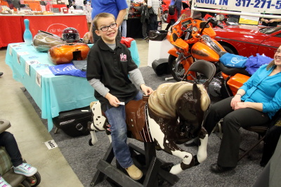 Grandson sitting on an old Carousel Horse