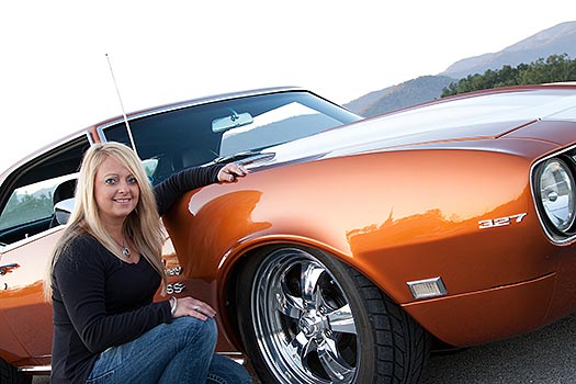 Michelle kneeling down with her car showing her Nitto wheels.
  