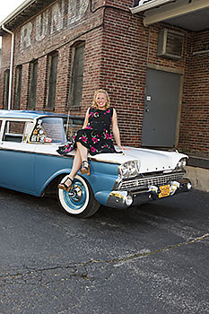 Sara Barnard sitting on the front hood of her 1959
