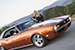 Michelle Harvey posing with partial 1968 Camaro